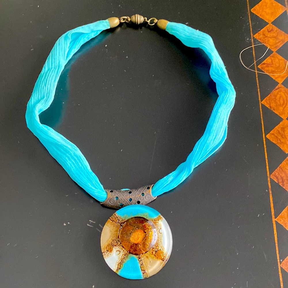 Costume jewelry necklace with glass pendant. Murano maybe. I don’t remember.